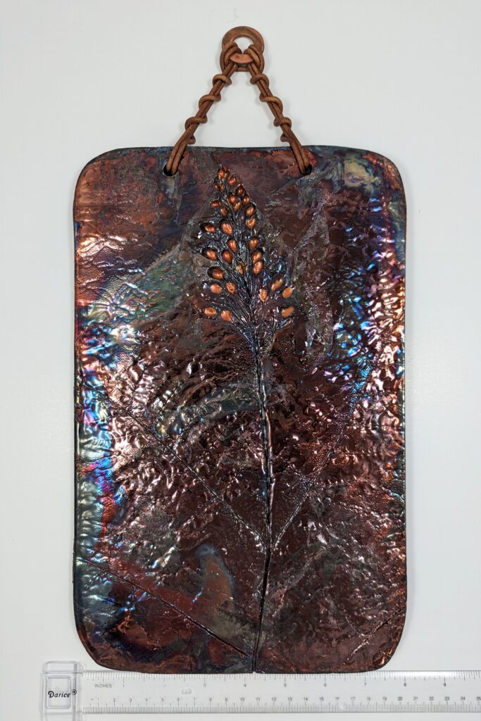 an impression of field plants pressed into clay